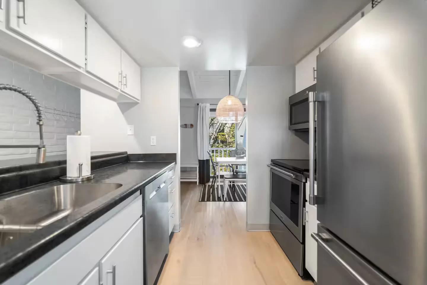 Modern stainless kitchen in a first short-term rental — how to become an airbnb host