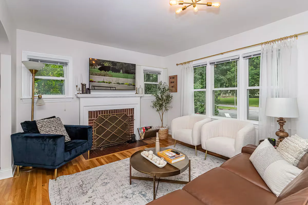 Bright, well-staged living room in a Stay-A-While managed rental — airbnb dynamic pricing
