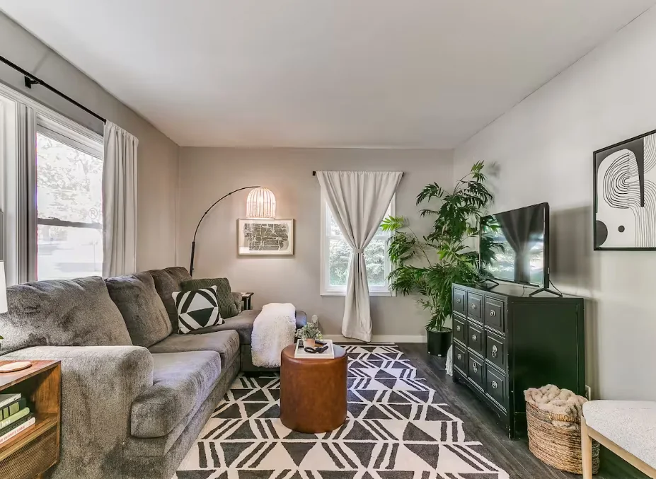 Property owner reviewing an insurance policy at a kitchen table in a managed rental — short term rental insurance